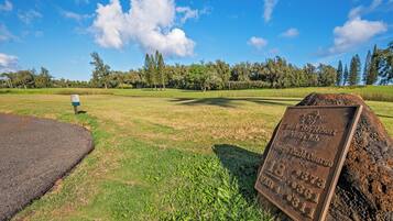 A golf course with a sign indicating hole number 18, par 4, and a score of 311.
