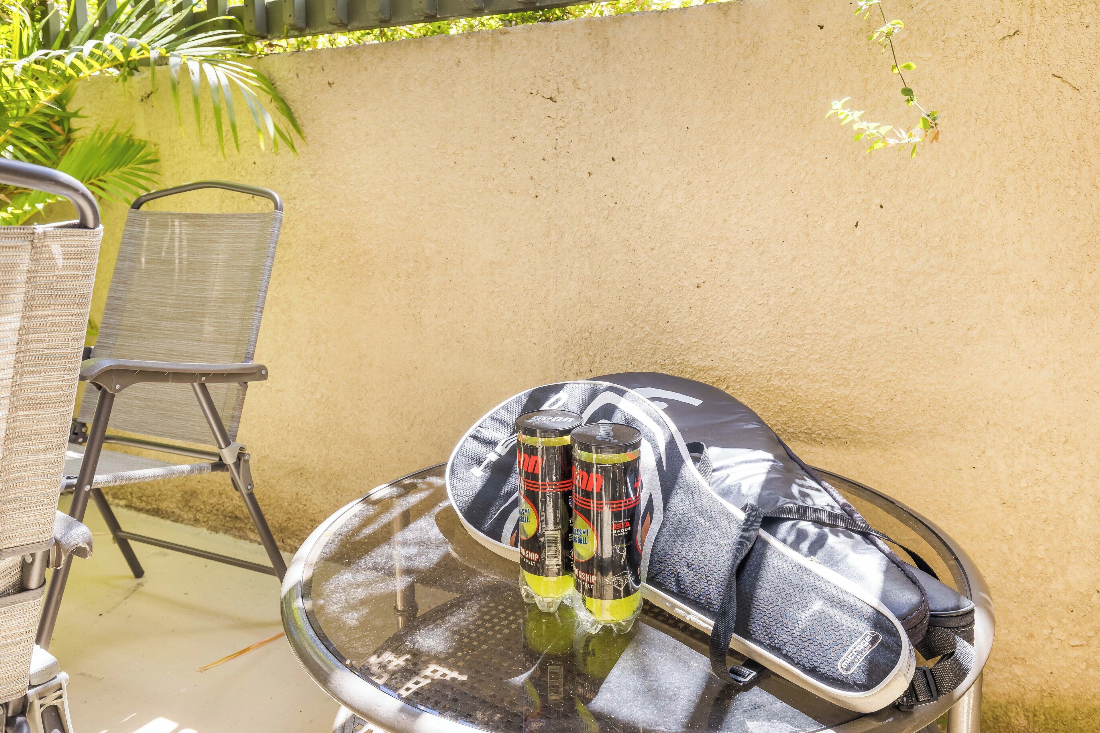 A table with a pair of shoes and two cans of energy drink.