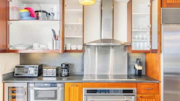 A kitchen with a built-in oven, a coffee maker, and a toaster.