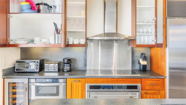 A kitchen with a built-in oven, a coffee maker, and a toaster.