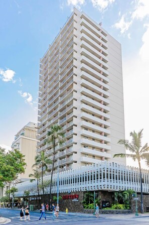 A tall hotel with multiple balconies, a restaurant named "Matteo's" at the base, and palm trees around. - Ocean-city Views at Marine Surf Close to the Beach W/parking & Full Kitchen (Honolulu)