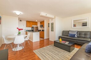 A modern apartment with a dining area, kitchen, and living room. - Ocean & City Views at Island Colony W/full Kitchen & Close to the Beach (Honolulu)