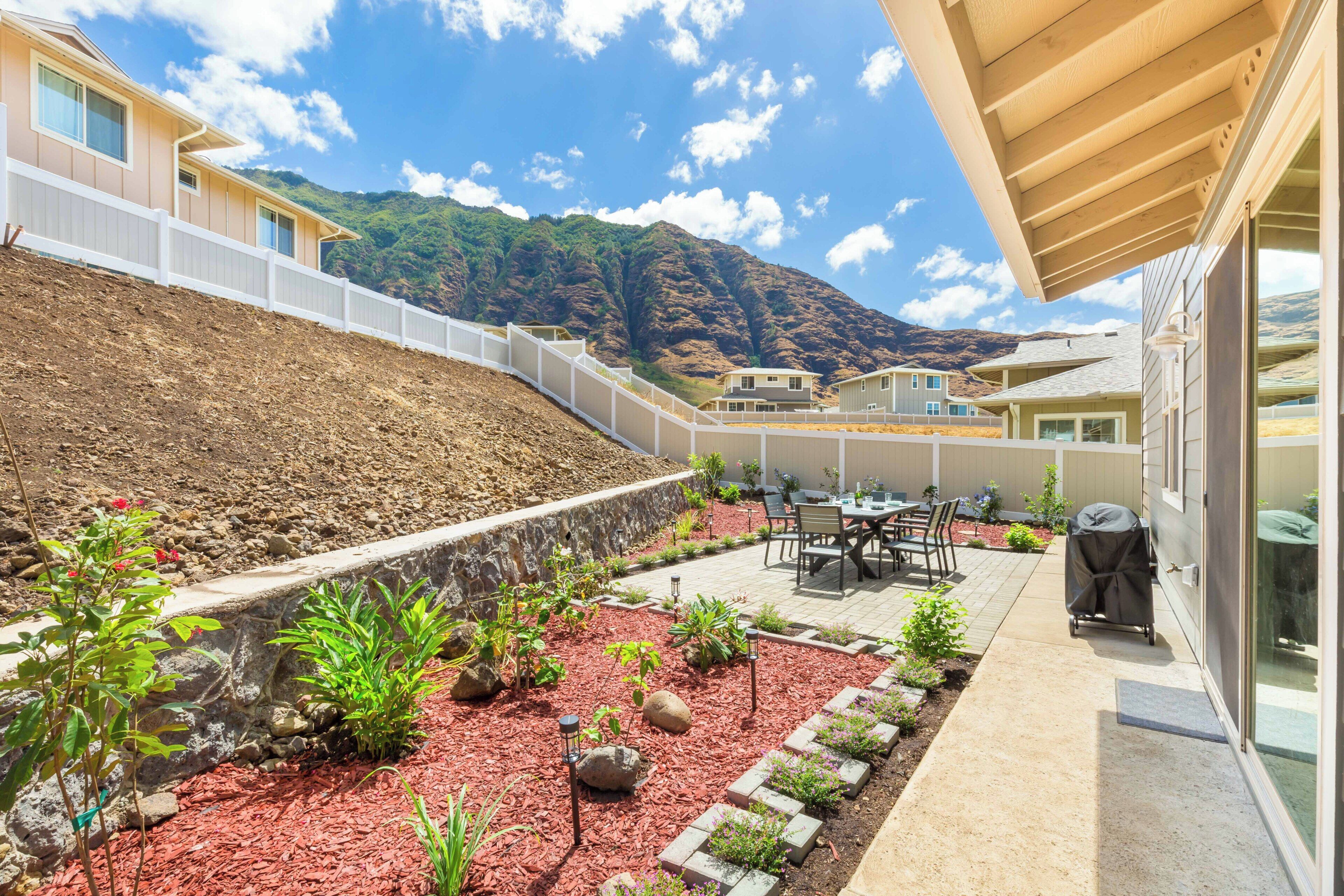 A residential area with a patio, outdoor seating, and a view of a mountain.