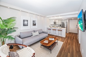 A modern apartment with a living area, kitchen, and dining space. - Ocean-lagoon Condo W/full Kitchen at Ilikai Hotel and Steps to the Beach (Honolulu)