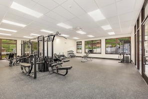 A gym with various exercise machines, large windows, and a clean, well-lit interior. - Ocean Views Serene Vacation Escape Home Near Beach W/beach Equipment & Games (Waianae)
