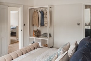 A bedroom with a bed, a wardrobe, and a bathroom.