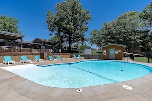 A swimming pool with lounge chairs, a lifeguard station, and a covered area with stairs. - Deluxe Notch Estates Cabin, Close to SDC - 4 BR Suites, 2 Living Areas - 35 (Branson West)