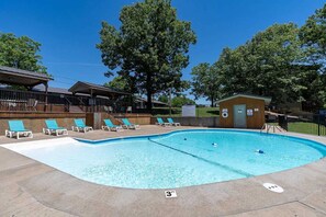 A swimming pool with lounge chairs and a lifeguard station. - Quiet Cabin1 mile to SDC - 4 Private Bed/Bath Masters, 2 Living Areas, 2 Pools! | 35 (Branson West)
