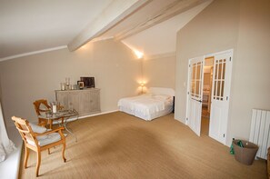 A bedroom with a bed, a bedside table, a chair, a small table with a lamp, and a wardrobe. - Maison Cerisaie - Four Bedroom Villa, Sleeps 8 (Pernes-les-Fontaines)