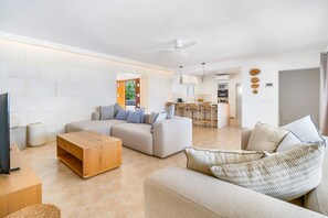 A modern living room with a sofa, a wooden coffee table, and a TV. - Villa Cley - Four Bedroom Villa, Sleeps 8 (Alayor)