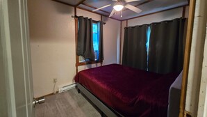 A bedroom with a single bed, a ceiling fan, and a window with curtains. - Lakefront views of Willscreek Lake 2 bedroom (Adamsville)