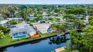 A residential area with houses, a swimming pool, and a canal. - Vibrant Haven: Private Dock • Games • Patio (Oakland Park)