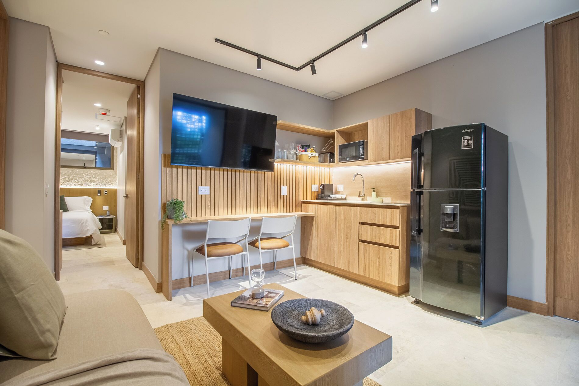 A compact living space with a kitchenette, a dining area, and a seating area.