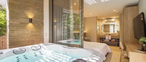 A modern bathroom with a large bathtub, a shower area, and a vanity with a mirror.