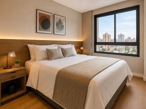 A hotel room with a large bed, a nightstand with a lamp, a small plant, and a window with a city view. - Fully equipped apartment with balcony, pool, and gym. (Barueri)
