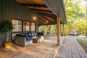 A covered outdoor seating area with a sofa and chairs, a hot tub, and a pergola. - Private 3-acre retreat with hot tub and fire pit (Rutherford County)