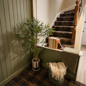 A staircase with a plaid carpet, a wooden handrail, and a green wall. - Fairytale Scots Baronial Coach House in Ballater, near Balmoral Castle (Ballater)