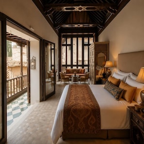 A hotel room with a large bed, a sofa, a small table, and a balcony. - YANGUAS NAZARI PALACE (Albaicin)