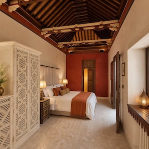 A bedroom with a bed, nightstands, a decorative cabinet, a mirror, and a wall-mounted light fixture. - YANGUAS NAZARI PALACE (Albaicin)