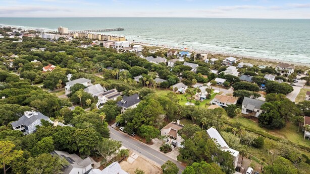 An aerial view of a coastal residential area with houses, roads, and a pier. - Folly Fun House – Just Steps to the Beach (Folly Beach)