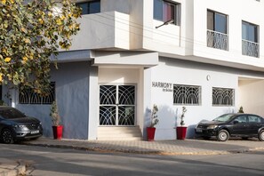 A modern building with a sign reading 'HARMONY by SabaLux'. - Cozy & Bright 2-Room Apartment in Dakar (Dakar)