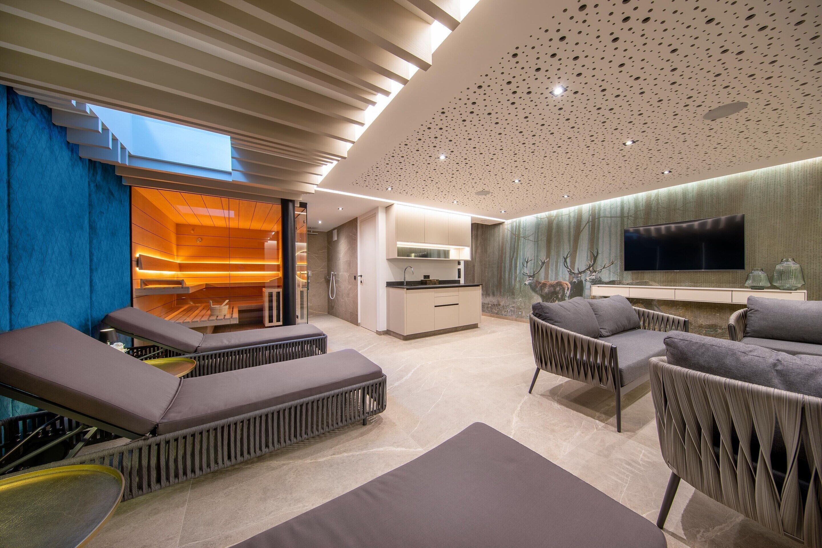 A modern interior with a lounge area, a kitchen, and a dining space.