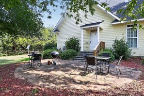 A house with a patio, outdoor furniture, and a barbecue grill. - Cozy Hunter s Retreat Wraparound Porch Fireplace (Thomson)