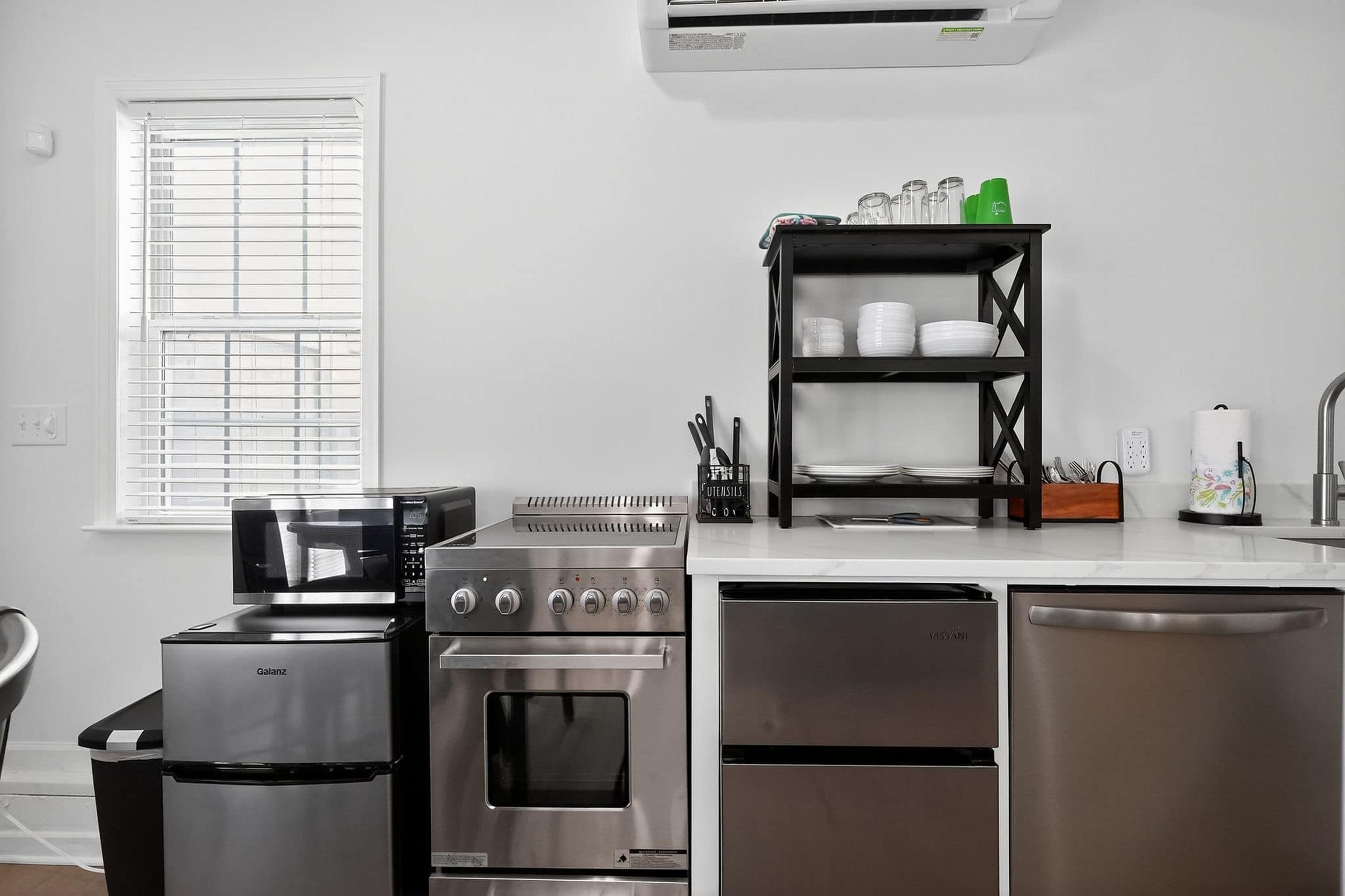 A modern kitchen with a built-in oven, microwave, and dishwasher.