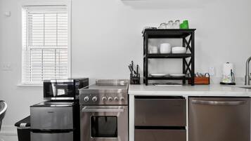 A modern kitchen with a built-in oven, microwave, and dishwasher.