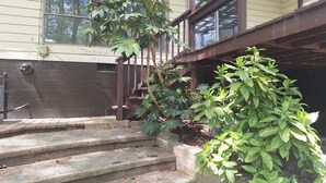 A residential building with a stone staircase leading to a wooden deck. - Quiet 2-bedroom house in fantastic Fairburn with cool AC. (Fairburn)