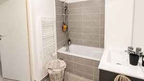 Ein modernes Badezimmer mit einer Badewanne, einem Waschbecken und einer Duschkabine.
