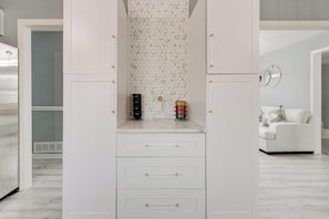 A white wardrobe with multiple drawers and a mirrored closet door. - Luxury, Romantic, Unique Retreat (Norcross)