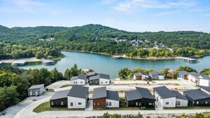 A residential area with modern houses, a lake, and a dock.