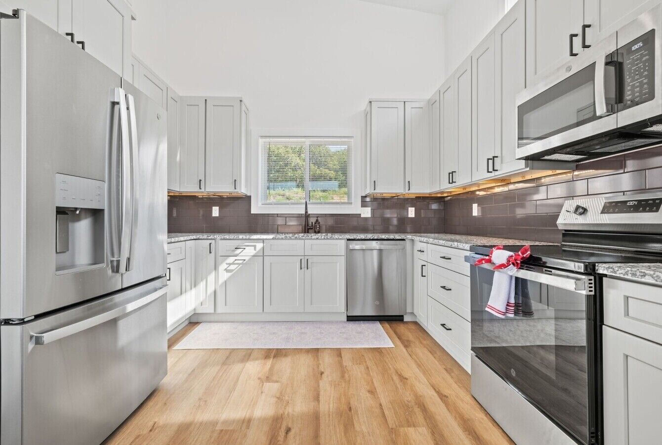 Fully equipped kitchen with stainless appliances and bar seating