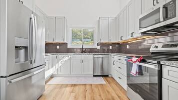 Fully equipped kitchen with stainless appliances and bar seating