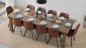 A dining table set for eight with brown chairs, white plates, and various dishes. - Jadeheim - Chalet 12 pers Spa et Sauna prives - Resort pres de Quebec (Shannon)