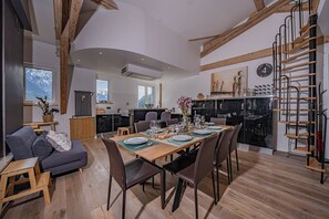Um interior moderno com área de jantar, cozinha e sala de estar.