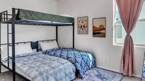 A bunk bed room with a window and two wall art pieces. - Modern Rio Rancho - Fireplace, Private Yard (Rio Rancho)