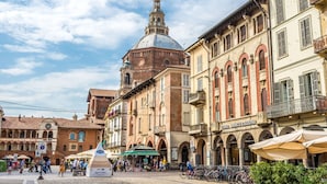 A historic square with a prominent church dome, traditional buildings, and a pedestrian zone.