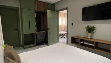 Una camera da letto con un letto grande, una scrivania e una televisione.