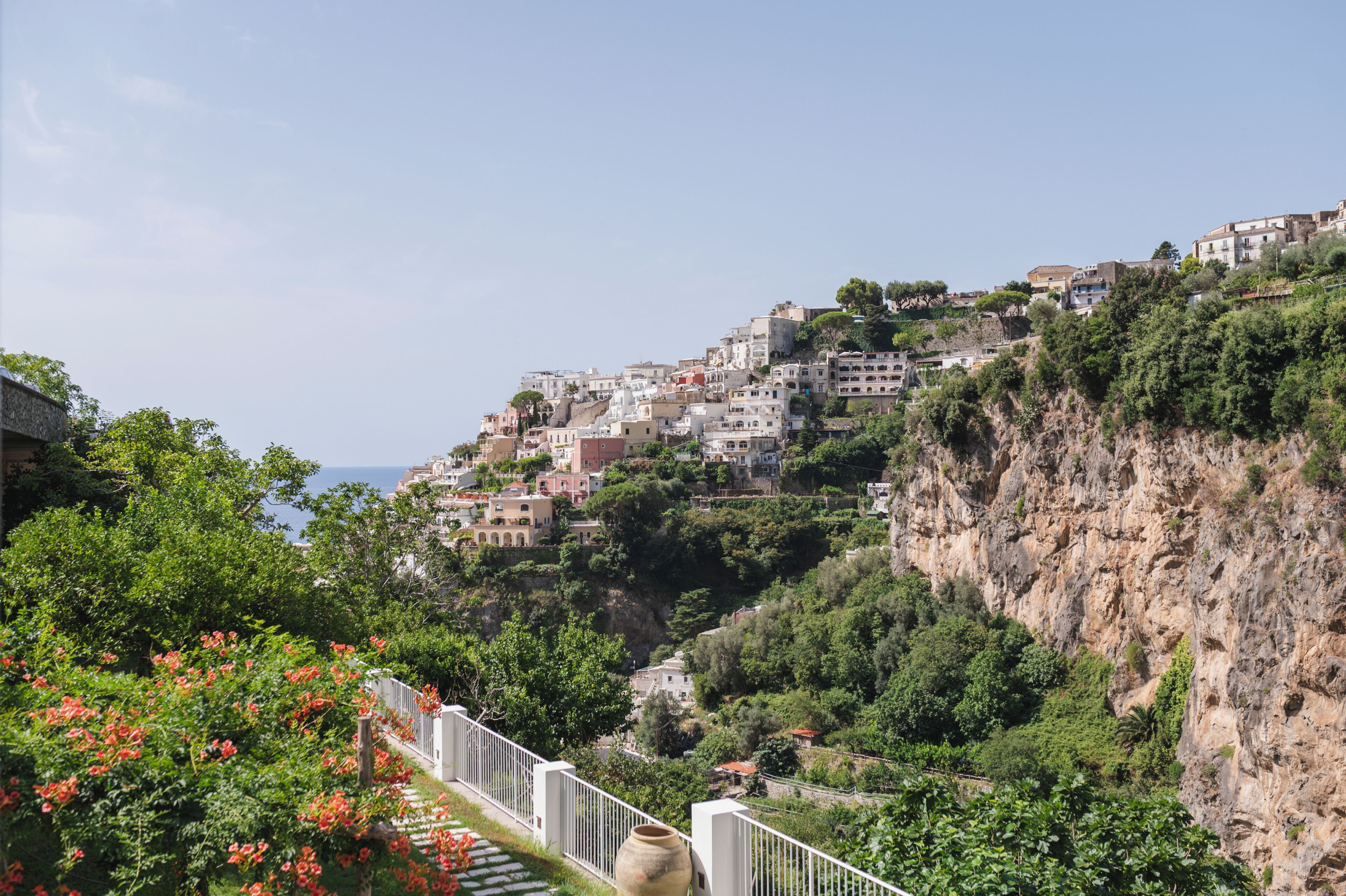 A coastal town with buildings built on a hillside, overlooking the sea.