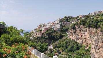 A coastal town with buildings built on a hillside, overlooking the sea.