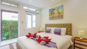 A hotel room with a large bed, a painting on the wall, and a balcony with a view.
