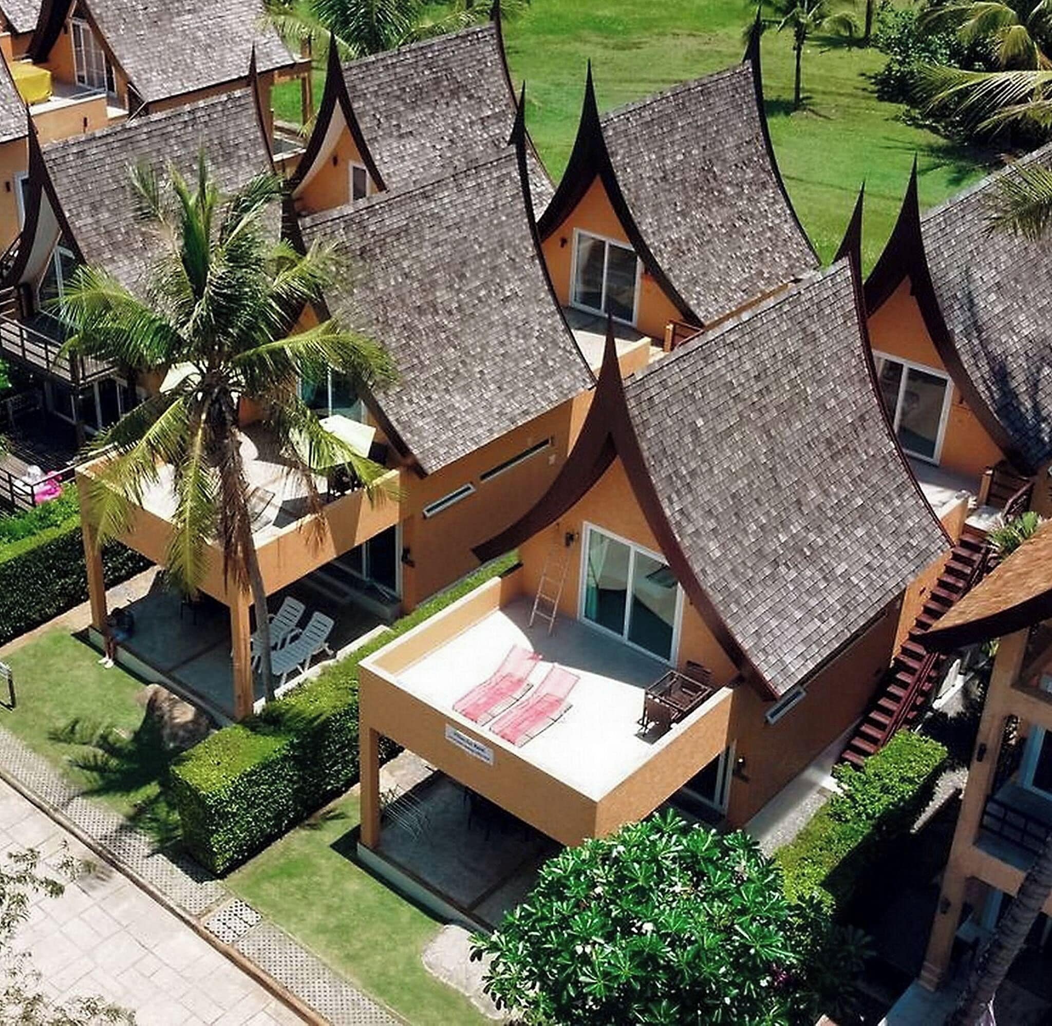 A resort with multiple bungalow-style buildings, each with a sloped roof and a balcony.