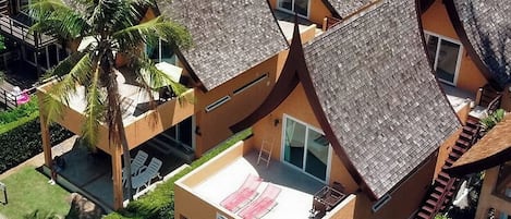 A resort with multiple bungalow-style buildings, each with a sloped roof and a balcony.