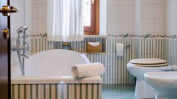 Ein Badezimmer mit Badewanne, Toilette und Dusche.