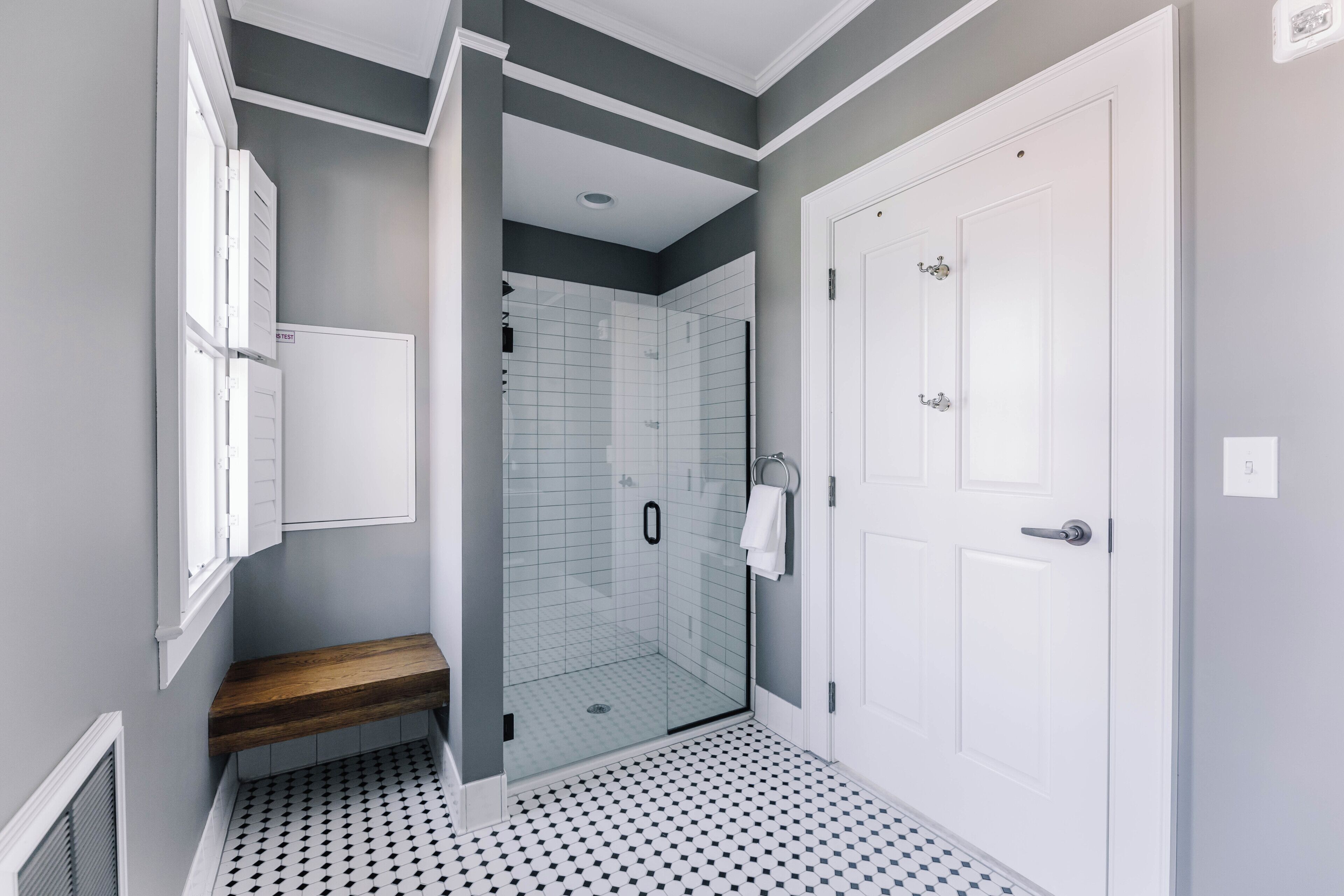 A modern bathroom with a shower, a toilet, and a sink.