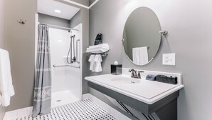 A modern bathroom with a shower, a sink with a mirror, and a towel rack. - First-Floor Queen Room with Mountain Views (Max Meadows)