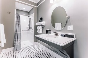 A modern bathroom with a shower, a sink with a mirror, and a towel rack. - First-Floor Queen Room with Mountain Views (Max Meadows)