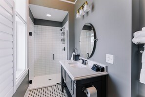 A modern bathroom with a shower, a sink, a mirror, and a toilet. - Historic Queen Room by New River Trail (Max Meadows)